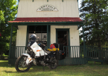 old fashioned general store building with white motorcycle in foreground